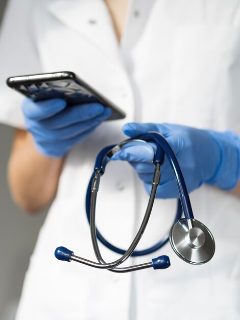 Close-up doctor holding smartphone