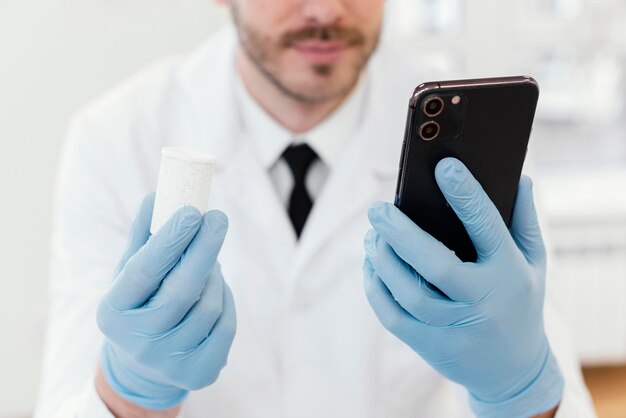 Close-up doctor holding smartphone