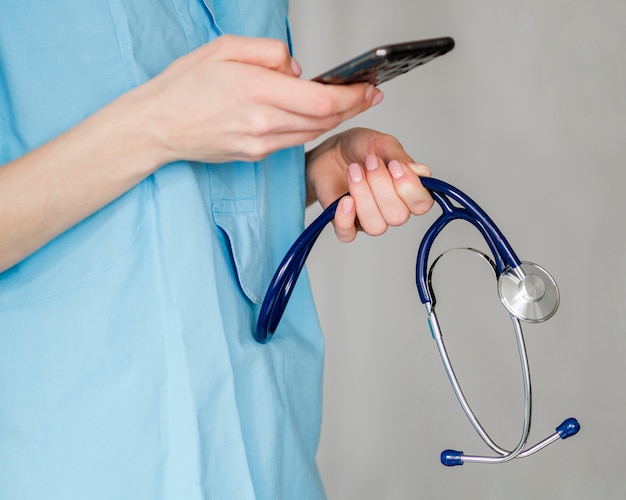 Close-up doctor holding stethoscope