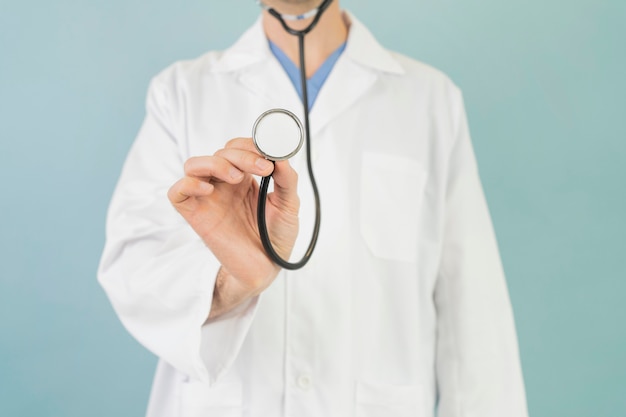 Close-up doctor holding stethoscope