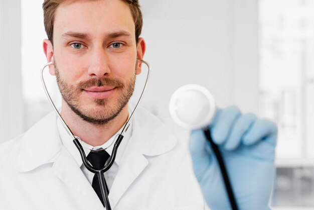 Close-up doctor holding stethoscope