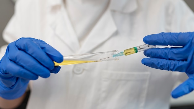 Close up doctor holding syringe and vial