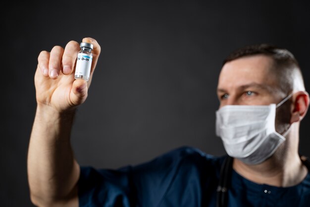 Close up doctor holding vial