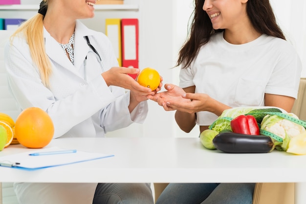 Close-up doctor and patient discussing about lemons