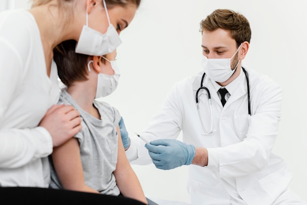 Close-up doctor and patient wearing mask