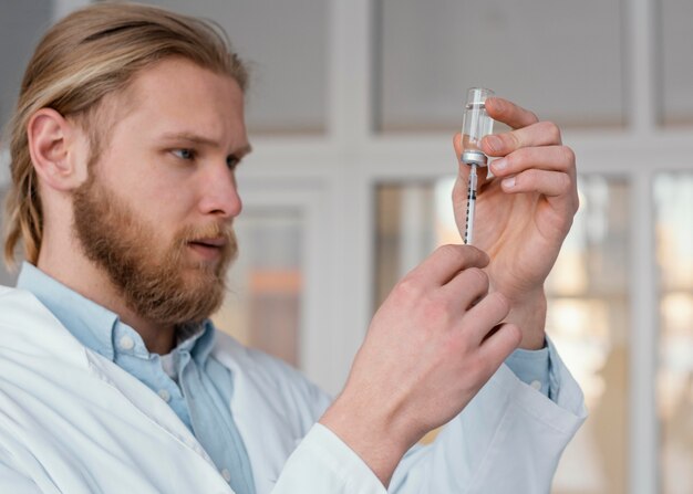 Close up doctor preparing injection