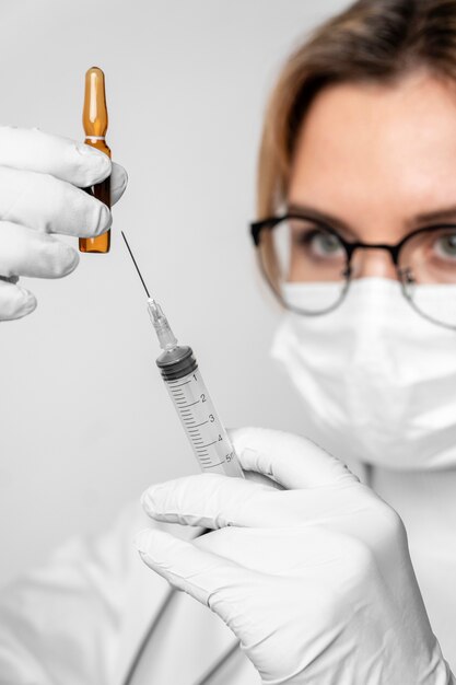 Close-up doctor preparing medical treatment