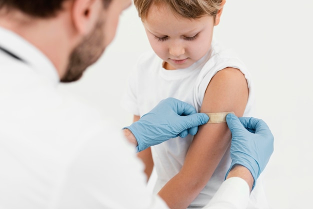 Close-up doctor putting on patch