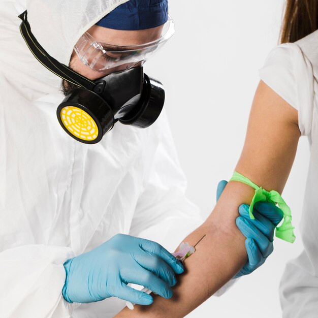 Close-up doctor taking blood sample from sick person