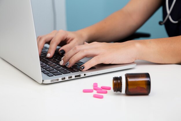 Close-up doctor using a laptop