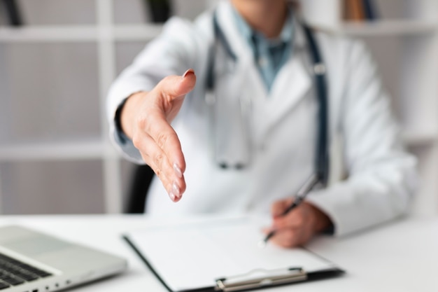 Free photo close-up doctor waiting to shake patients hand