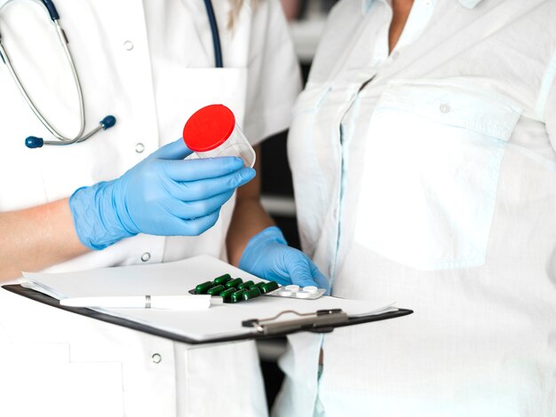 Close-up doctor wearing gloves