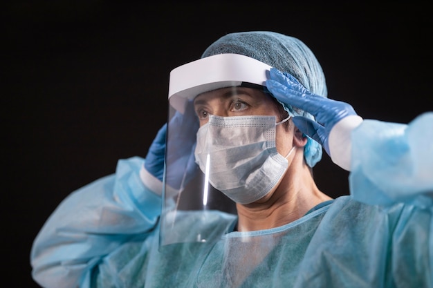 Free photo close up doctor wearing protection equipment