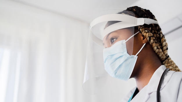 Close-up doctor wearing protective equipment