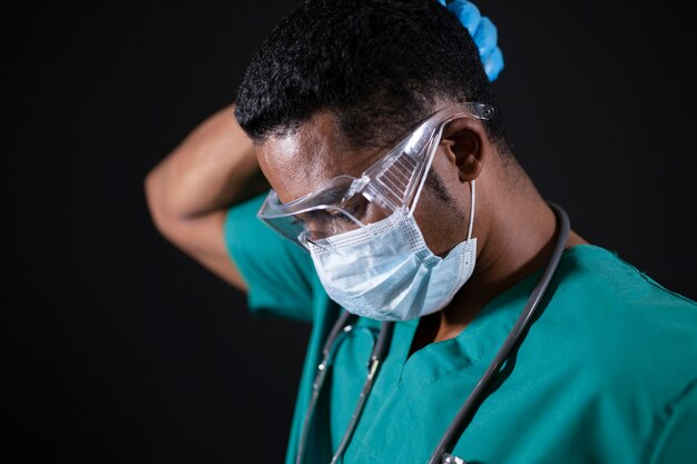 Close up doctor with goggles and mask