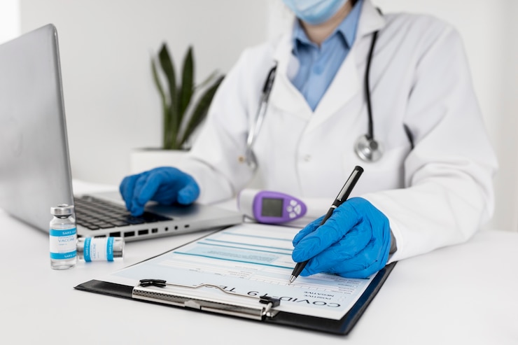 Free Photo close-up doctor working on laptop