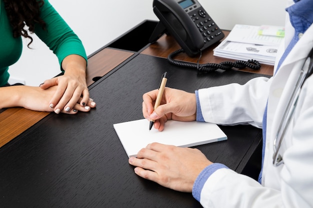 Close-up doctor writing a prescription