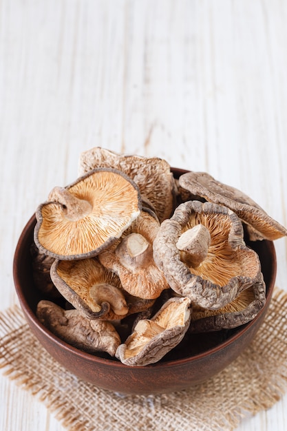 Foto gratuita chiuda su dei funghi di shiitake secchi su fondo di legno