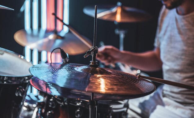 Close-up of a drum cymbal as the drummer plays.