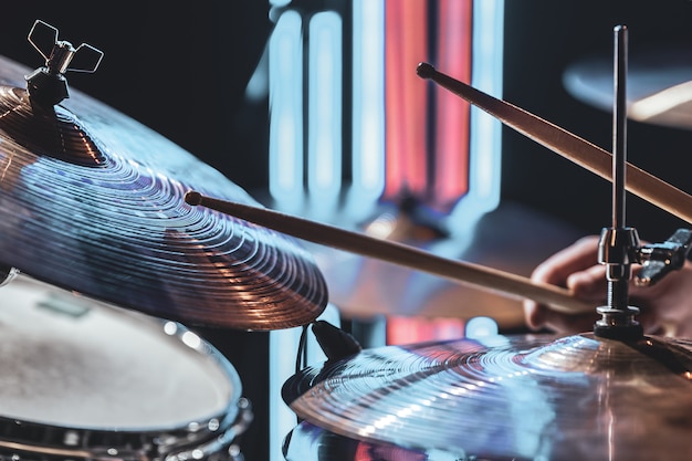 Close-up of drum cymbals as the drummer plays with beautiful lighting