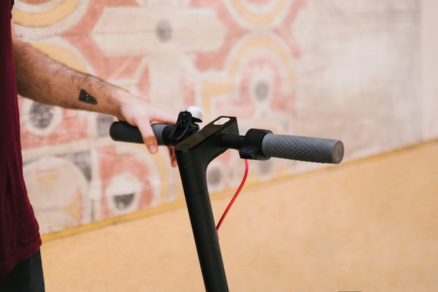 Close up e-scooter handle with geometric background