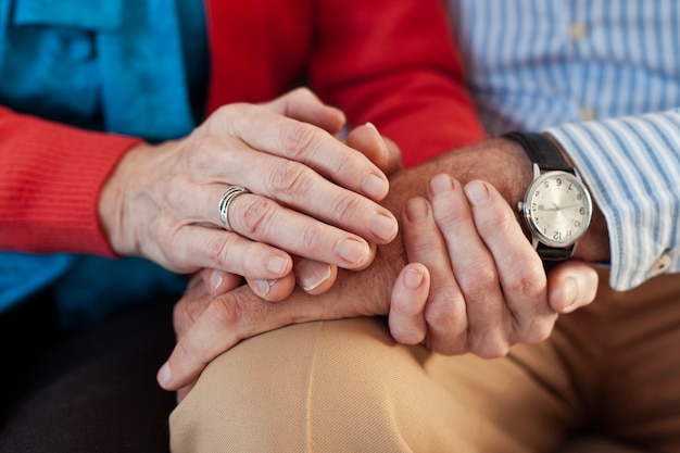 Free photo close-up elderly couple holding hands