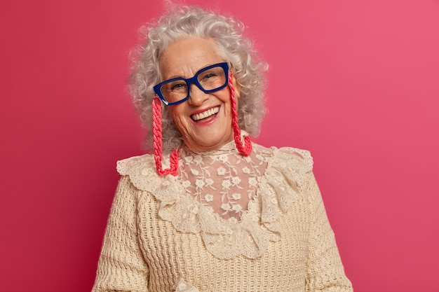 Close up on elegant elderly woman wearing stylish clothes isolated