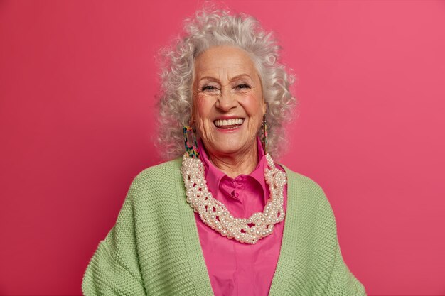 Close up on elegant elderly woman wearing stylish clothes isolated