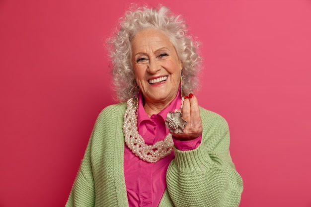 Close up on elegant elderly woman wearing stylish clothes isolated