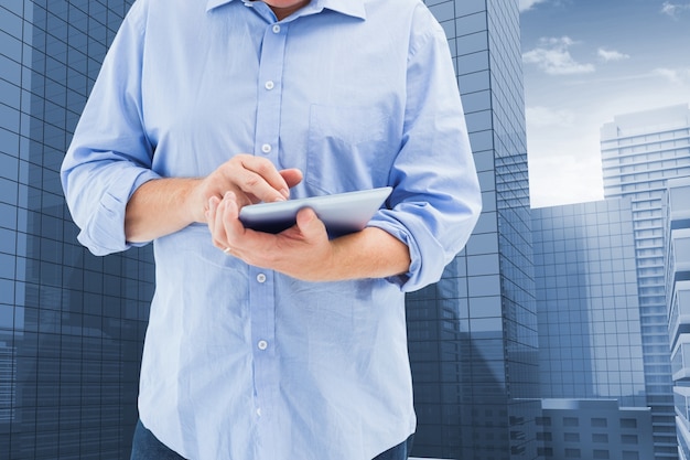 Free photo close-up of employee using a tablet with buildings background