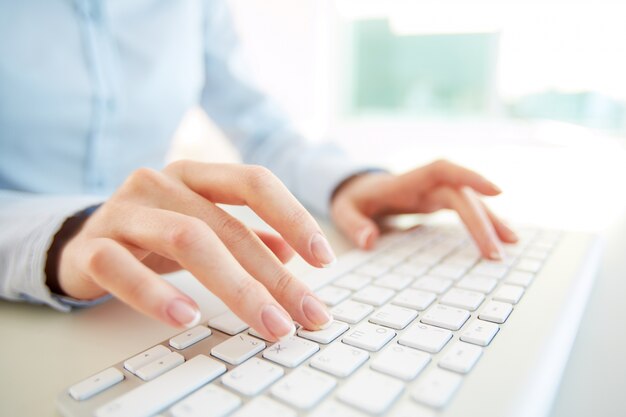 Close-up of employee with computer keyboard