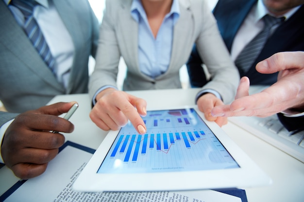 Free photo close-up of employees looking at business document