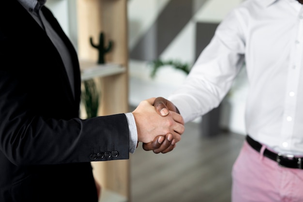 Close up of employees shaking hands