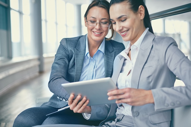 Close-up of entrepreneurs working with a tablet