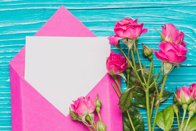 Close-up of envelope with blank note and flowers