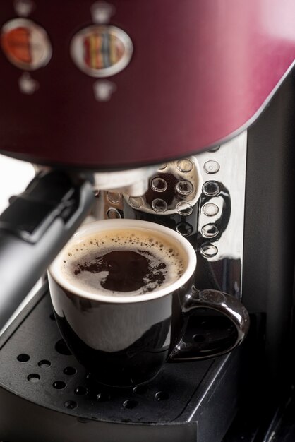 Close-up espresso machine with a cup