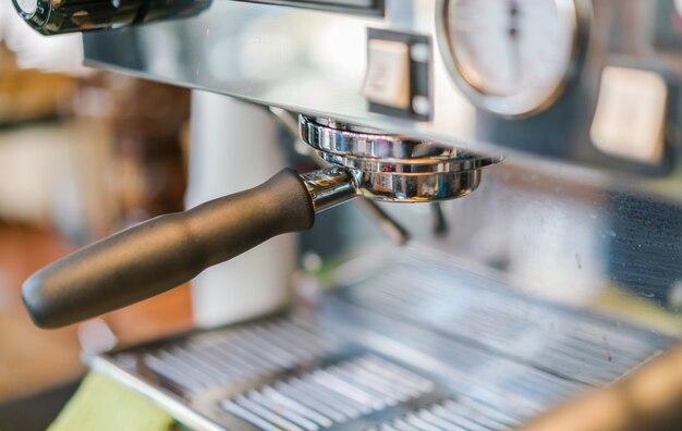 Close-up of espresso pouring from coffee machine .