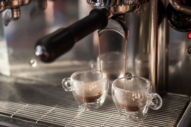 Close-up espresso pouring into cups