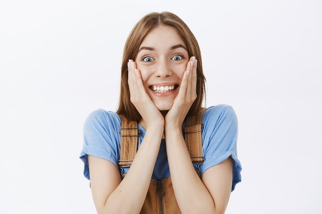 Close-up of excited happy girl rejoicing from awesome news and smiling