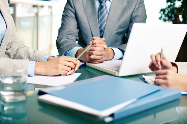 Free Photo close-up of executives sitting at the table