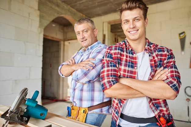 Close up on experienced carpenter and his younger employee