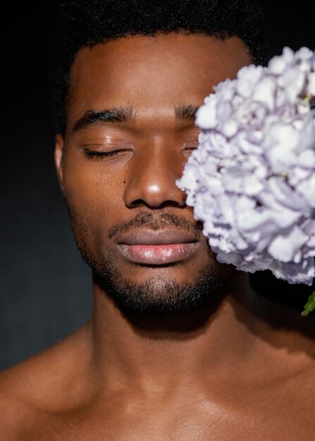 Close-up expressive man posing with flowers