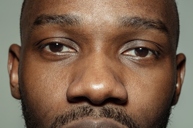 Close up of face of beautiful african american young man, focus on eyes