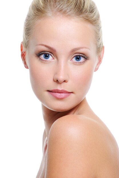 Close-up face of beautiful caucasian blonde woman with blue eyes over white
