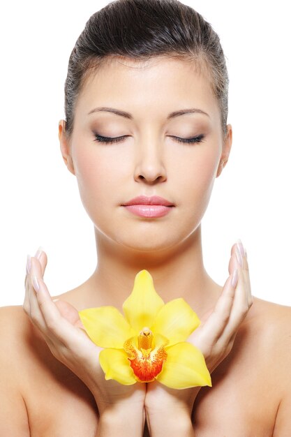 Close-up face of a beauty asian woman relaxation with flower in hands