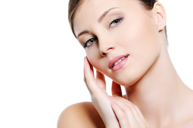 Close-up face of young sexy  female with clean skin - over white background