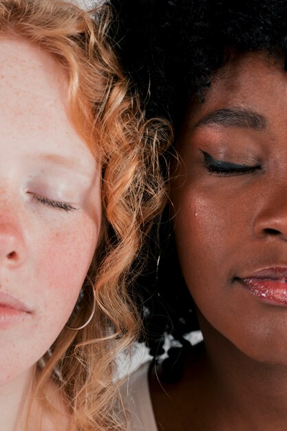 Close-up of fair and dark skinned women face