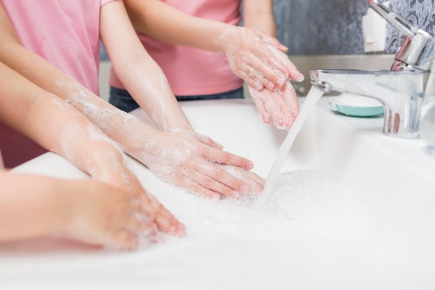 Close-up family cleaning hands