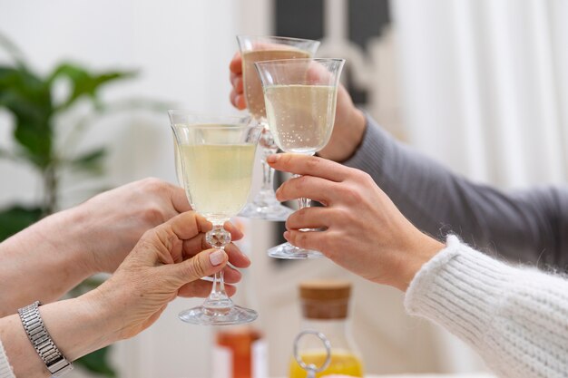 Close up family clinking glasses