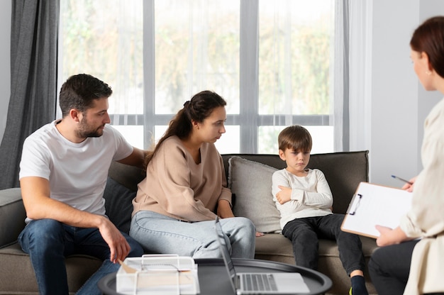 Close up family discussing with therapist